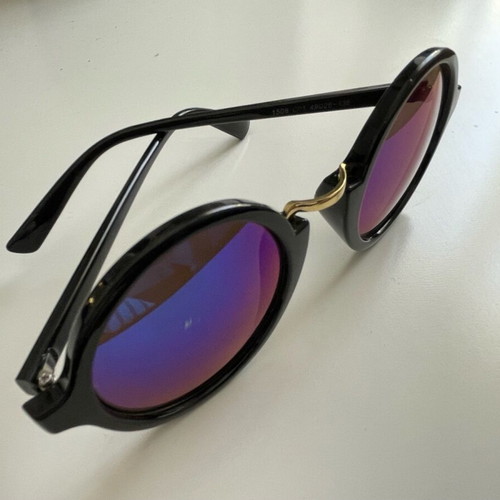 Sunglasses with round iridescent lens used, black frame with gold detail