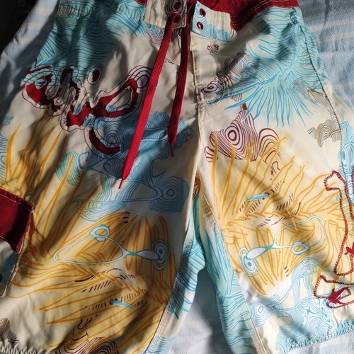 Aggressive men's swim shorts size L like new, multicolor tribal print