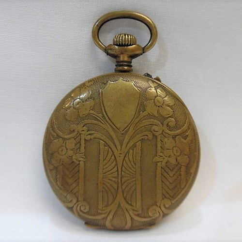 Old brass pocket watch with embossed design