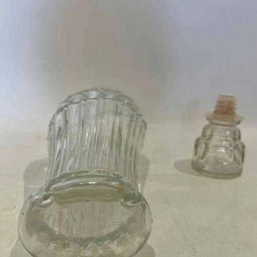 Vintage glass carafe with embossed designs used