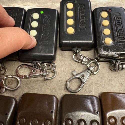 Garage door remotes used, set of 10, one broken with tape