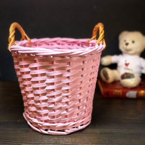 Decorative pink rattan basket with gold handles, handmade