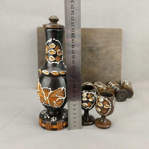 Vintage carved painted wooden bottle with 6 glasses on wooden tray used