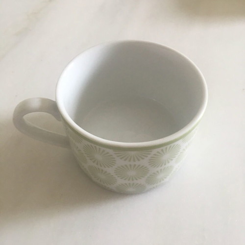 Vintage porcelain cup with light green daisy decorations like new