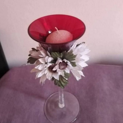 Glass candlestick used with floral wreath and burgundy candle