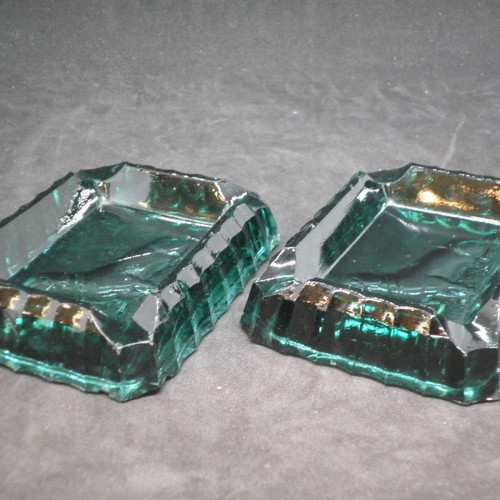 Antique ashtrays pair used with embossed dogs in dark green glass
