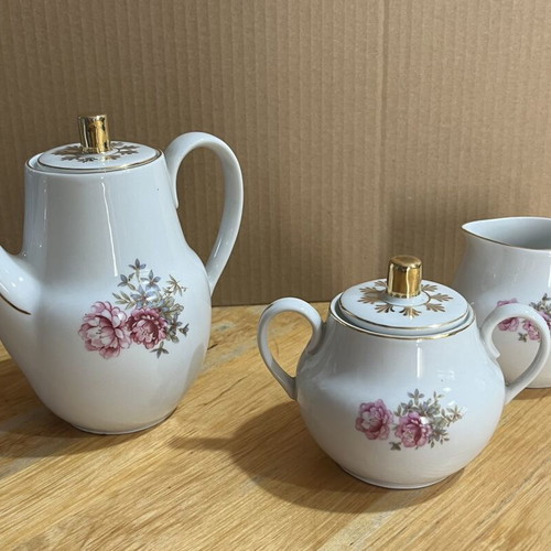Porcelain tea set used with floral pattern, teapot, creamer, sugar bowl
