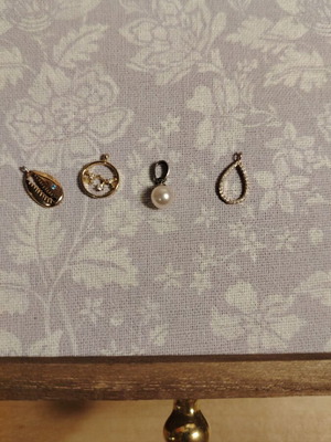 Set of 4 elegant pendants like new, pearl and rhinestone designs