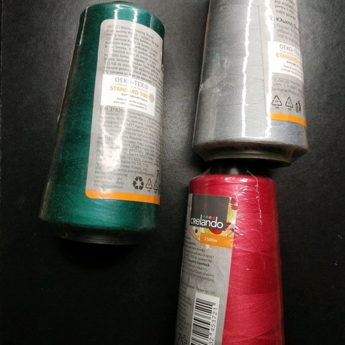 Set of new threads for sewing machine in green, gray and red