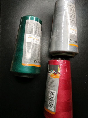 Set of new threads for sewing machine in green, gray and red