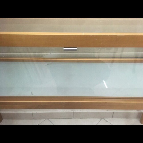 Console used with wooden frame and glass surfaces