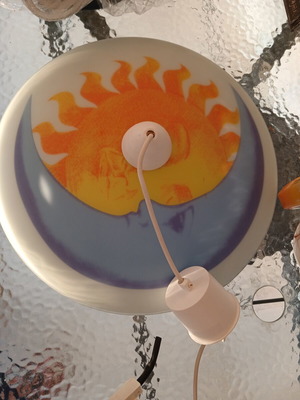 Ceiling light fixture with sun and moon design