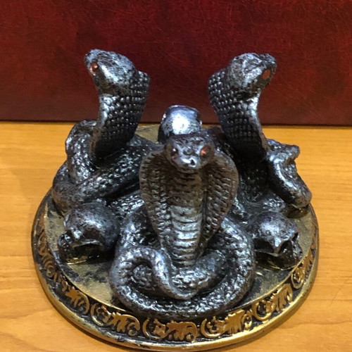 Decorative figurine with snakes and skulls