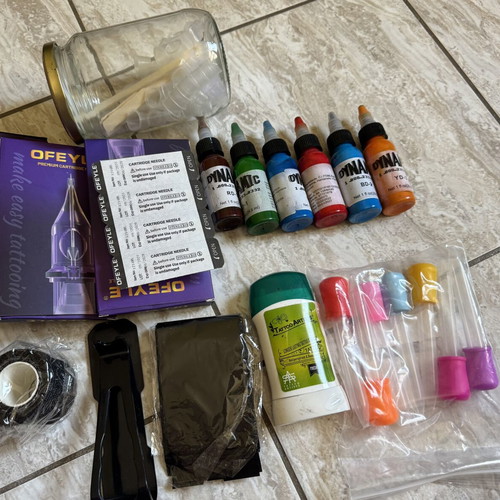 Tattoo supply kit with cartridges, inks, and accessories
