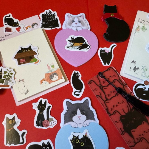 Cat-themed stationery set like new with sticky notes, pens, bookmarks, and stickers