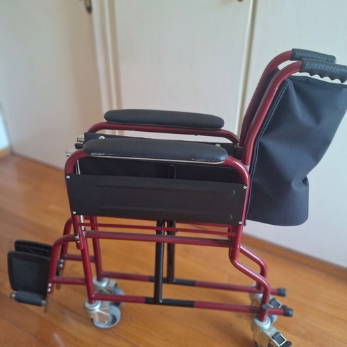 Transport wheelchair with metal frame and brakes
