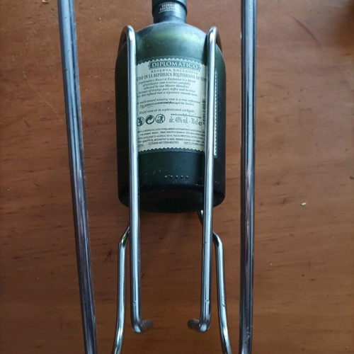 Bottle holder stainless like new with collectible rum bottle