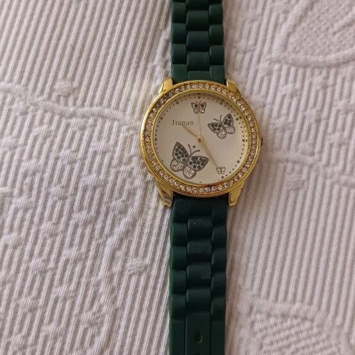 Women's watch like new with green rubber strap and butterfly dial