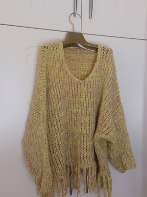 Knitted Poncho like new in orange color with fringes