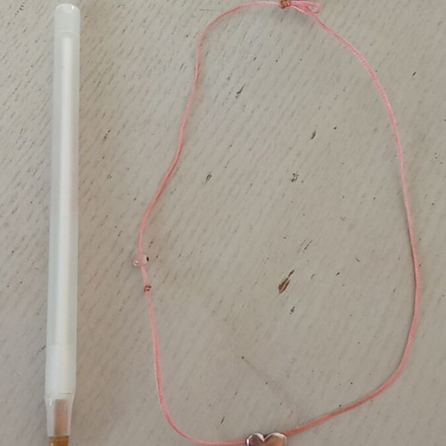Silver heart pendant with pink eye on pink thread like new