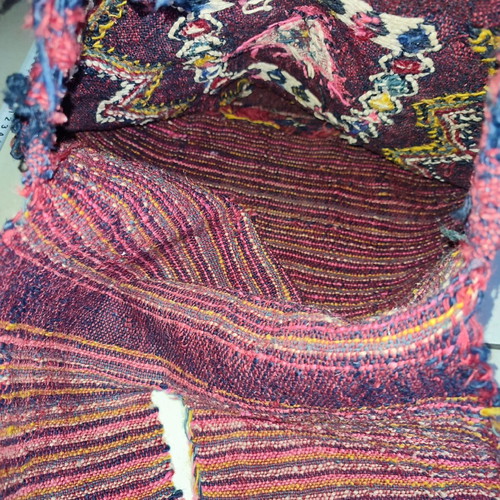 Old woven double horse saddle bag used with fabric tears