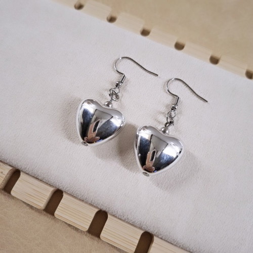 Heart design earrings in silver tone