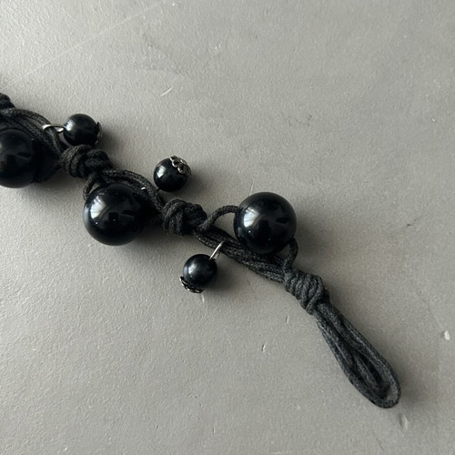 Black bracelet with beads and silver details like new, adjustable knot