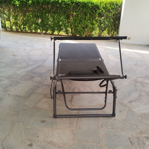 Black sunbed with moveable umbrella and comfort pillow like new