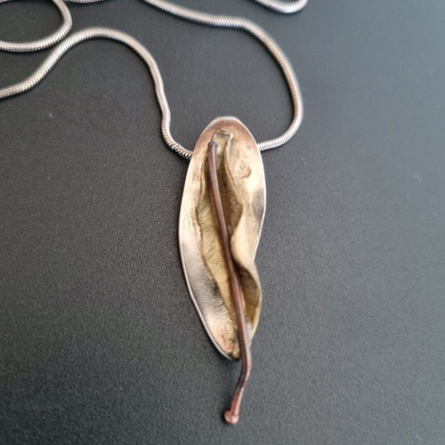 Silver handmade jewelry used with mixed materials leaf design