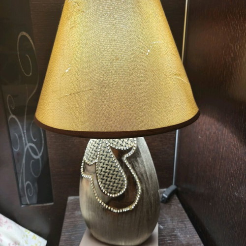 Table lamp used with switch in golden shade