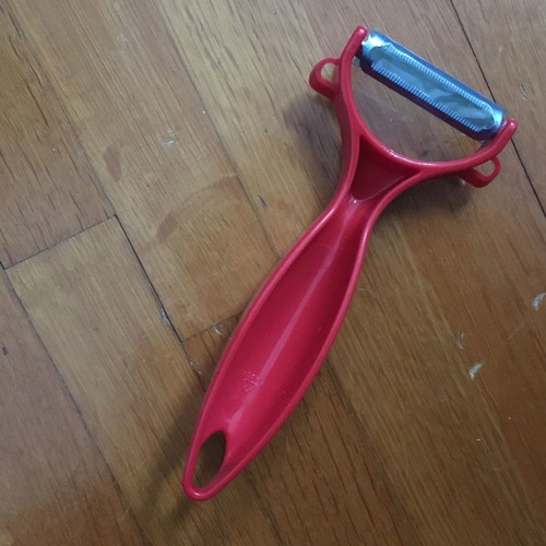 Red peeler new with thick handle made of durable plastic
