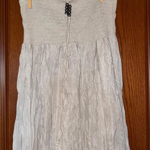 Long beige strapless dress used with honeycomb detail and neck tie