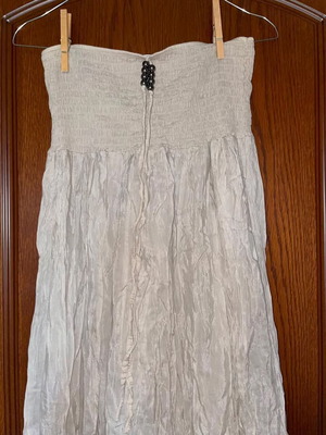 Long beige strapless dress used with honeycomb detail and neck tie