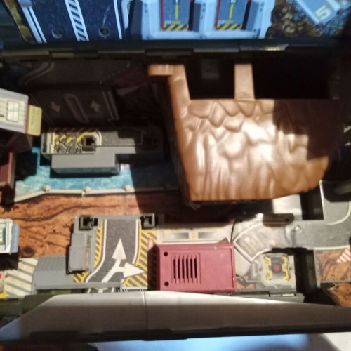 Micro machine military vehicle hiding a small city like new
