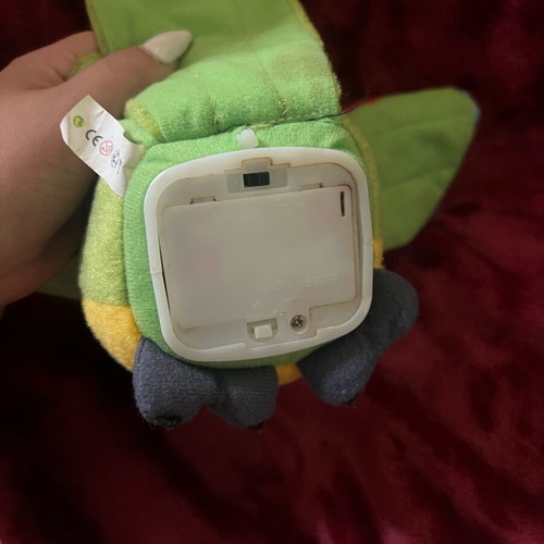 Plush parrot like new that talks and moves its wings