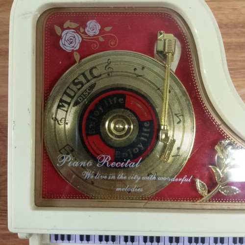 White piano music box with golden record and rose design