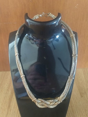 Metal necklace with bow and wire rope used