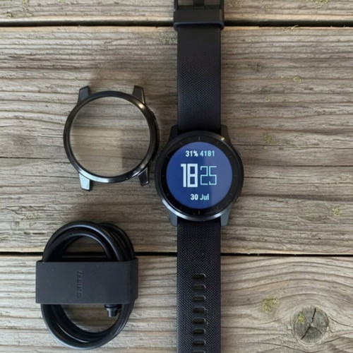 Garmin Vivoactive 4 smartwatch used, with charging cable and straps
