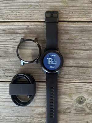 Garmin Vivoactive 4 smartwatch used, with charging cable and straps