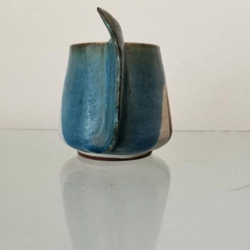 Clay handmade mug used with wavy handle