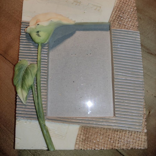 Ceramic photo frame with embossed flower and notes, used