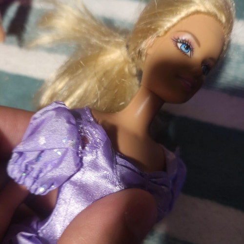 Barbie with lilac dress used, torn shoulders