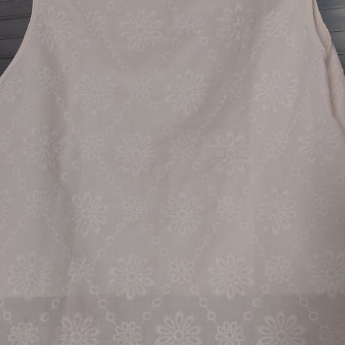 White sleeveless blouse with embroidered flowers