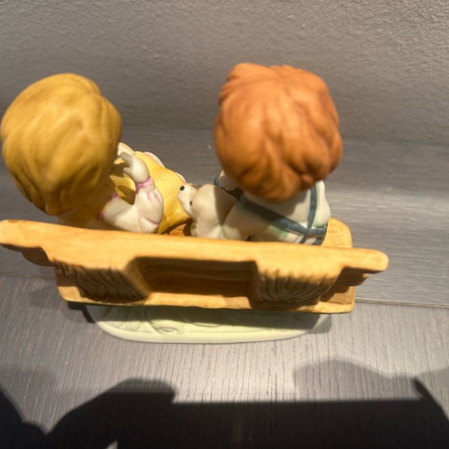 Porcelain decoration with two children on bench like new