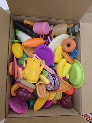 Large box of used children's kitchen toys with plates and utensils