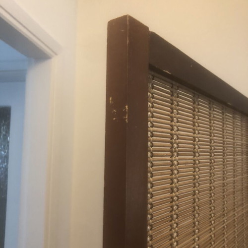 Brown bamboo room divider with slight wear
