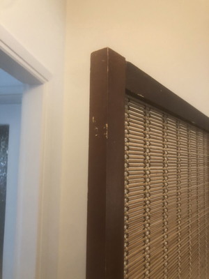 Brown bamboo room divider with slight wear