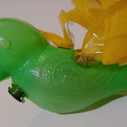 Plastic bird-shaped whistle used, green color