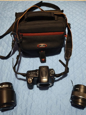 Sony A500 camera used with two lenses, battery, SD card, and carrying case