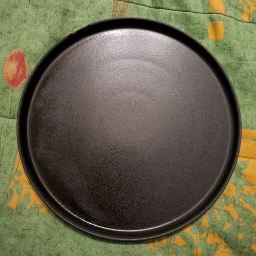 Porcelain plate used, black with small chip